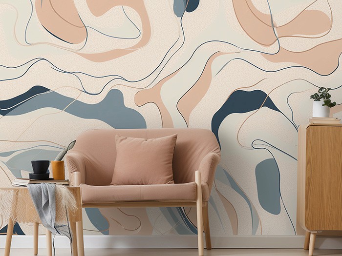 Wall painted with artistic design set behind an accent chair and table.